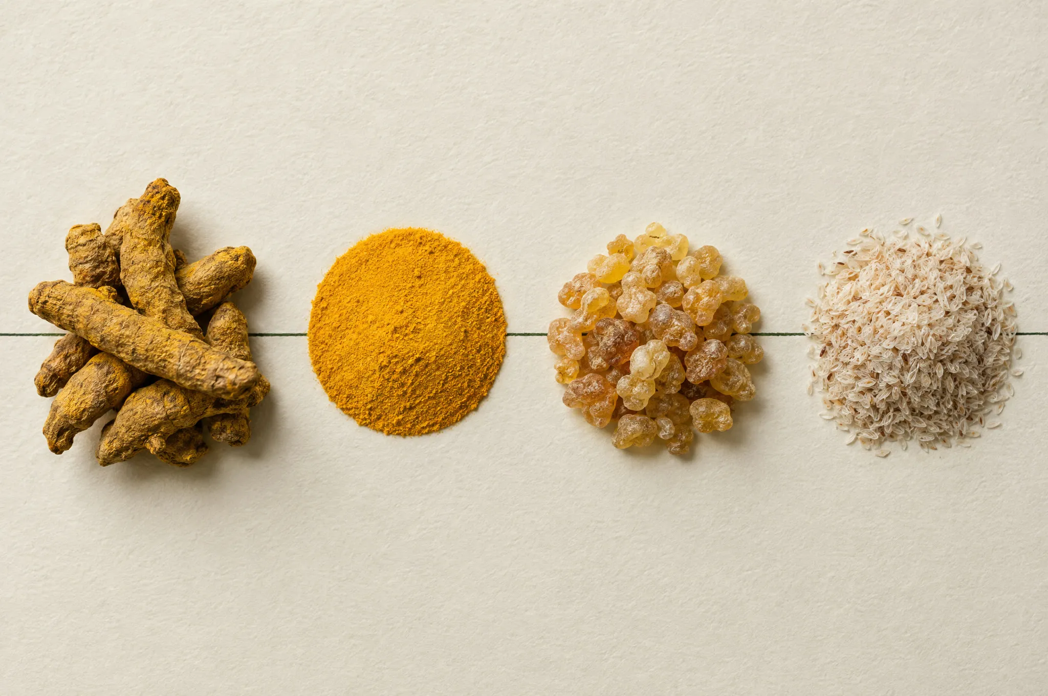 Turmeric roots, curcumin powder, boswellia resin and psyllium husk in a row